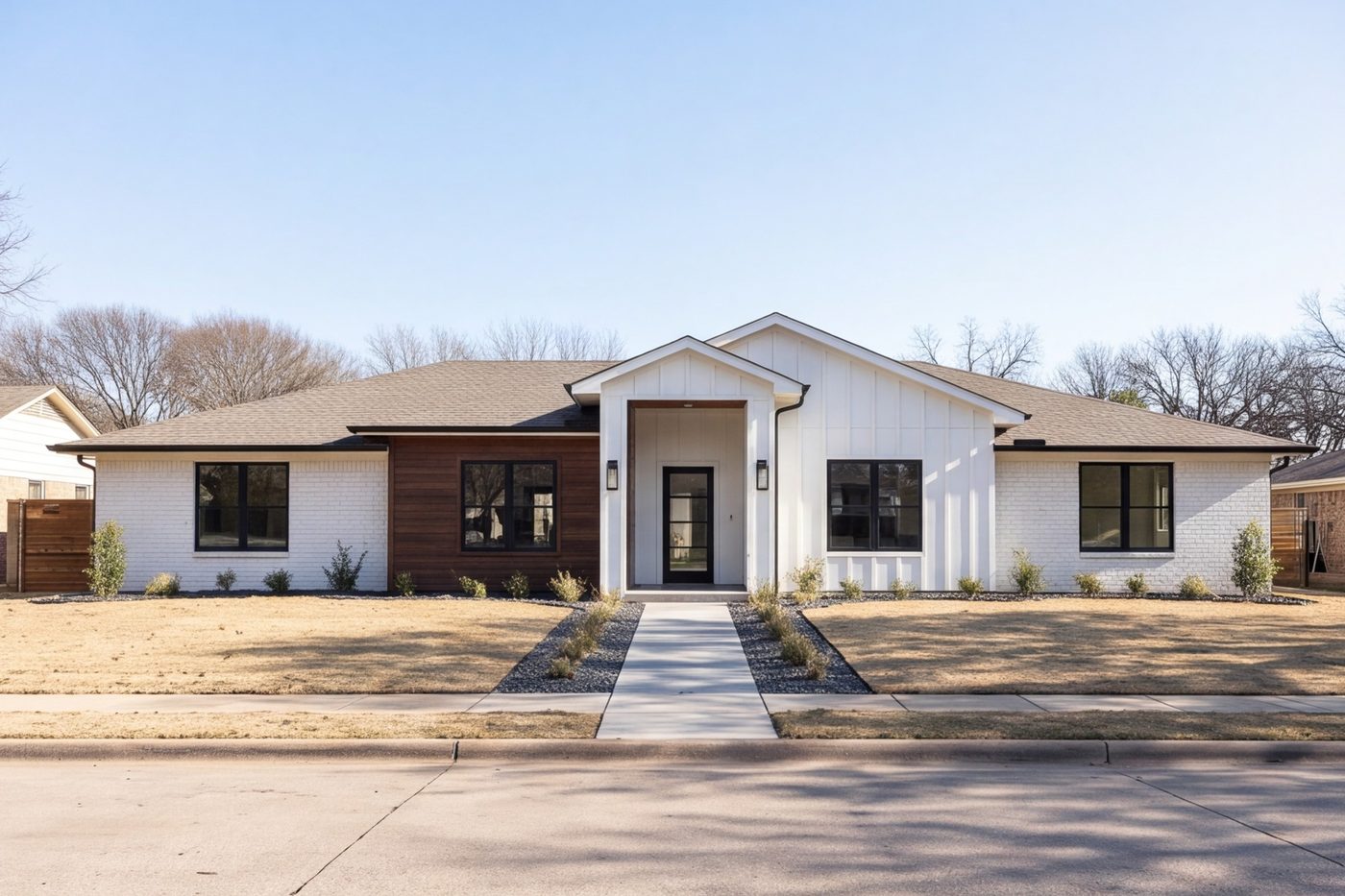 Front of a remodeled brick ranch home with new siding and entry